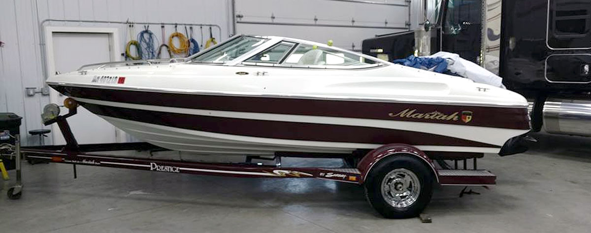 Speed boat sitting inside the detailing shop at NCS Auto & Detail in Sauk Centre, MN